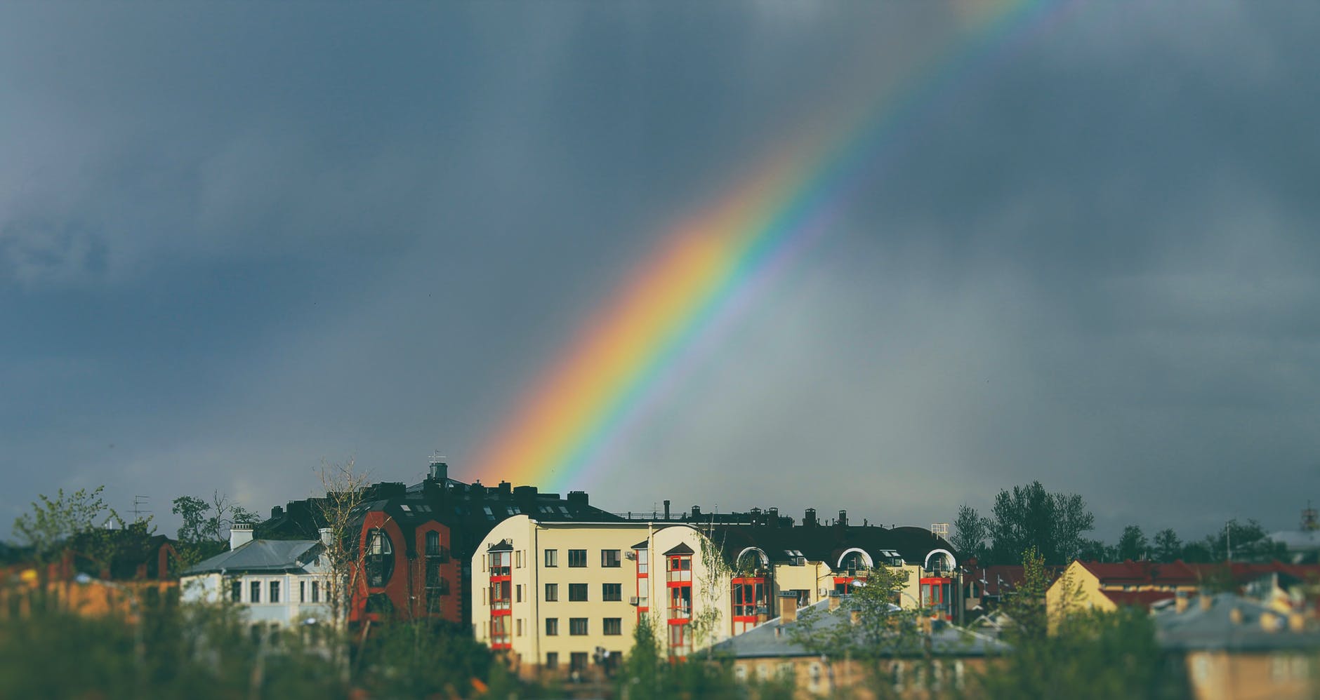 rainbow on sky over buildings